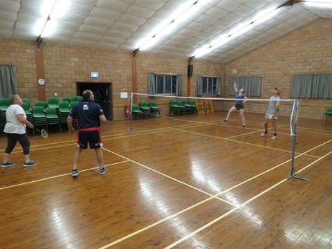 People playing badmitton inside Yamma Hall