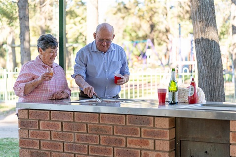 Older couple cooking a barbecue 