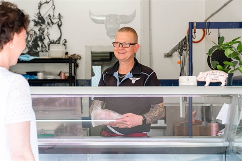 Butcher with customer in Healths butchery